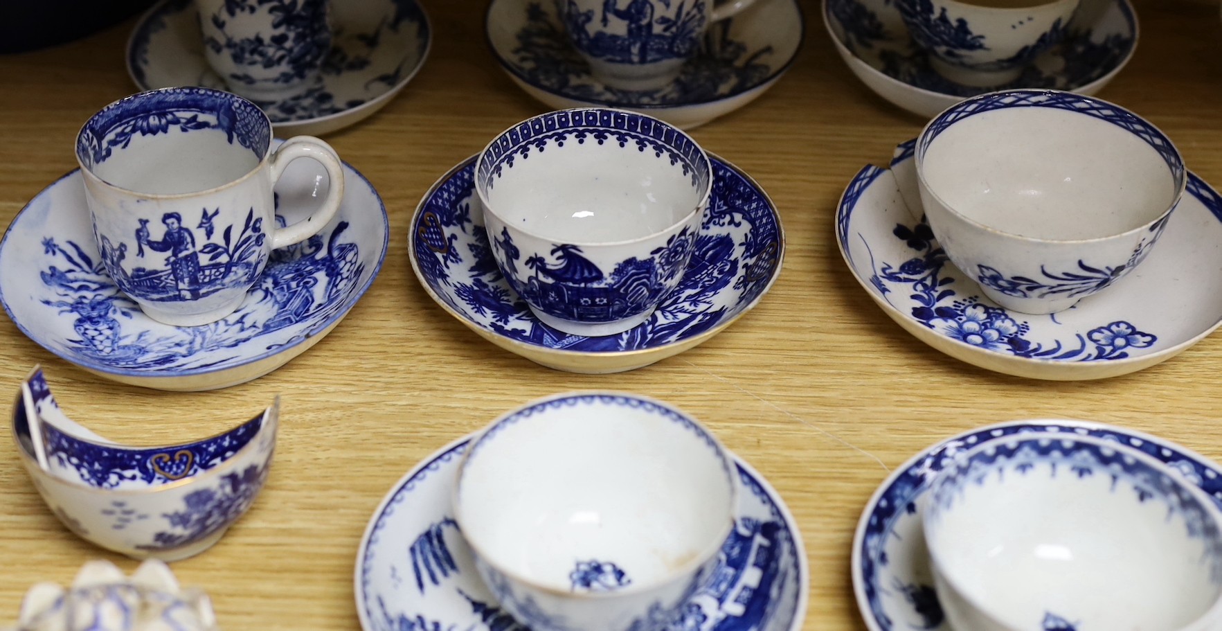 A large group of 18th century Worcester, Caughley and Liverpool blue and white tea bowls, coffee cups and saucers etc. including a Bow Cross-Legged Man